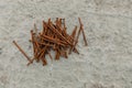 Top view of a stack of rusty nails on floor