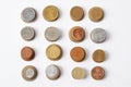 top view of stacks of different coins on white