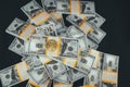 Top view of stacks of dollar bills on which lies a bitcoin coin on a black background. The concept of making a profit Royalty Free Stock Photo