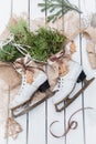 Top view of stages of making Christmas decoration of old vintage ice skates with ribbons