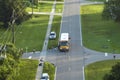 Top view of standard american yellow school bus picking up kids at rural town street stop for their lessongs in early Royalty Free Stock Photo