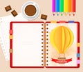 Top view of stationary pencils, red cover notebook and coffee cup with chocolate, paper 3D craft air balloon