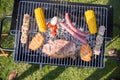 Top view of steak, sausages and fresh vegetables on BBQ Royalty Free Stock Photo