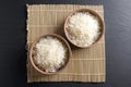 Top view: steamed cooked basmati rice in round ceramic bowls over black stone Royalty Free Stock Photo