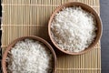 Top view: steamed cooked white basmati rice in round ceramic bowls over black stone