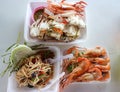 Top view steamed crab meat dipping spicy Thai style seafood Grilled Shrimp and Papaya Salad