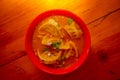 Top view of steamed soup of Momo served in a red bowl. A popular Nepalese food that is also common in Chiana, Bhutan