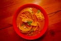 Top view of steamed soup of Momo served in a red bowl. A popular Nepalese food that is also common in Chiana, Bhutan