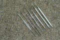 Top view steel ear pick kit on stone background, object, copy space