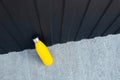 Top view of steel thermo water bottle of yellow color on the concrete floor against metal background of black color. Copy space Royalty Free Stock Photo