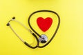 Top view stethoscope and red heart shape on yellow background. For check heart or health check up concept Royalty Free Stock Photo