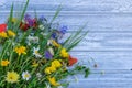 Top view on still life with bouquet of spring wild flowers on wooden background Royalty Free Stock Photo