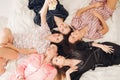 Pretty girls in pyjamas taking selfie on bed. Royalty Free Stock Photo