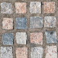 Top view on stone road. Abstract background of cobblestone pavement closeup. Brown texture of paving stone track Royalty Free Stock Photo