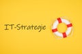 Top view of IT-Strategie written on yellow background with a marine cork hoop Royalty Free Stock Photo