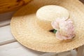 Top view of straw beach hat on wood background.