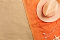 Top view straw hat and headphones with copy space. Traveler accessories on sand