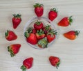 Top view of strawberries in a bowl and some on the table