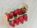 Top view of strawberries in a bowl and some on the table