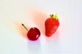 Top view of a strawberry and one cherry on a white background effect Royalty Free Stock Photo