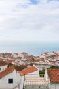 Top view of the streets with white houses and orange tiled roofs, an ancient portuguese city on the ocean Royalty Free Stock Photo