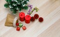Top view studio shot of Christmas eve festival decorative items small sack bag full of gift present boxes Red candles Pine seeds Royalty Free Stock Photo