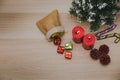 Top view studio shot of Christmas eve festival decorative items small sack bag full of gift present boxes Red candles Pine seeds Royalty Free Stock Photo