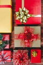 Top view studio shot pattern of colorful paper wrapped present gift boxes with gold red green and silver shiny glossy ribbon bow