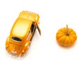 Top view studio shot small orange toy car with mini pumpkin isolated on white Royalty Free Stock Photo