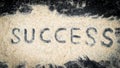 Top view of success text written on white sand Royalty Free Stock Photo