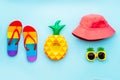 Top view summer beach, pool vacation concept with rainbow color flip flops, pineapple inflatable drink holder, pink Royalty Free Stock Photo