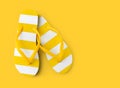 Top view of summer beach yellow striped flip flop isolated in yellow background sea holiday vacation and travel concept Royalty Free Stock Photo