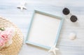 Top view of summer blue picture frame with sunglasses and seashell and star fish and pink flower decoration on white wood table. Royalty Free Stock Photo