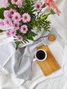 Top view of summer or spring flowers and a cup of coffee in bed Royalty Free Stock Photo