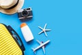 Top View Summer Travel and Plan.  Yellow suitcase luggage with accessories fashion, old camera, sunblock on the colorful backgroun Royalty Free Stock Photo