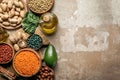 Top view of superfoods, legumes, olive oil and healthy ingredients on rustic background