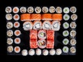Top view of sushi rolls philadelphia and california placed in a square of small maki rolls. Royalty Free Stock Photo