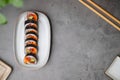 Top view of sushi rolls of tuna, cucumber, and avocado with copy space of the black concrete table