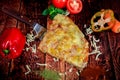 Top view of sweet Hawaiian homemade pizza slice with fresh veggies decor on wooden background