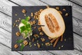 Top view of a sweet, organic melon on a dark background. A glass of honeydew, ice and mint. A composition of healthy ingredients. Royalty Free Stock Photo