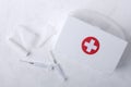 Top view of bandage, syringes, plastic white first aid kit on the white surface Royalty Free Stock Photo