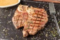 Top view of T-Bone Steak served on stone plate with sauce on the side Royalty Free Stock Photo
