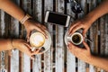 Top view of table with coffee and friends couple enjoying drinks and break - females caucasian hands and phone and sunlgasses on Royalty Free Stock Photo