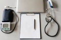 Top view table doctor work desk with laptop, Blood pressure, Stethoscope with clip board and pen. Royalty Free Stock Photo