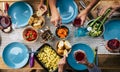 Top view of table full of food and riends enjoying event together - blue dishes and colorful background - concept of no