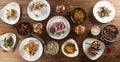 Top view of a table full of various meals for vegetarians and meat eaters served on plates and in pans Royalty Free Stock Photo