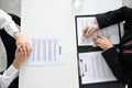 Top view of a table with a senior female HR manager and a candidate in a job interview Royalty Free Stock Photo