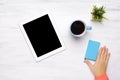 Top view of tablet computer and cup of coffee on wooden table Royalty Free Stock Photo