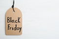 Top view of tag with words BLACK FRIDAY on wooden background. Space for text Royalty Free Stock Photo