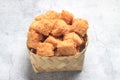 Photo top view, tahu krispi or crispy Tofu at bamboo bowl, besek under brown abstract marble